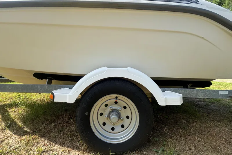 Slide: The Image of 2004 Sea-Doo Sportster LE DI boat trailer wheel on grassy ground. - 39