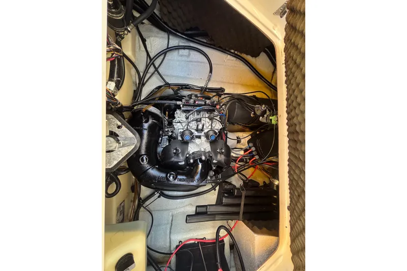 Slide: The Image of Engine compartment of a 2004 Sea-Doo Sportster LE DI boat, showcasing intricate wiring and components. - 44