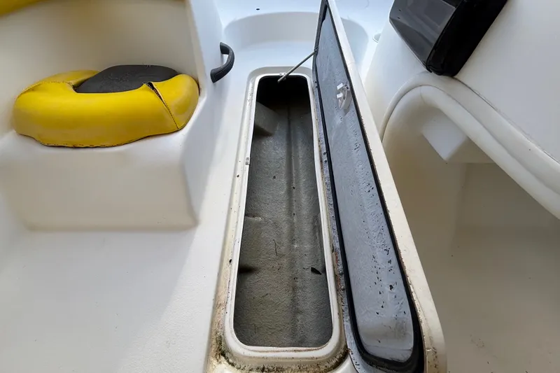 Slide: The Image of 2004 Sea-Doo Sportster LE DI boat storage compartment with yellow seat detail. - 26