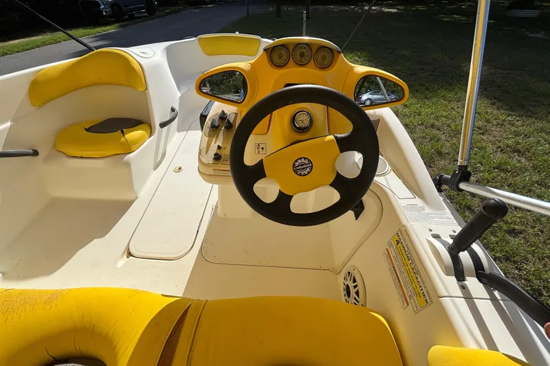 Slide: The Image of 2004 Sea-Doo Sportster LE DI boat interior with yellow seating and steering wheel. - 14