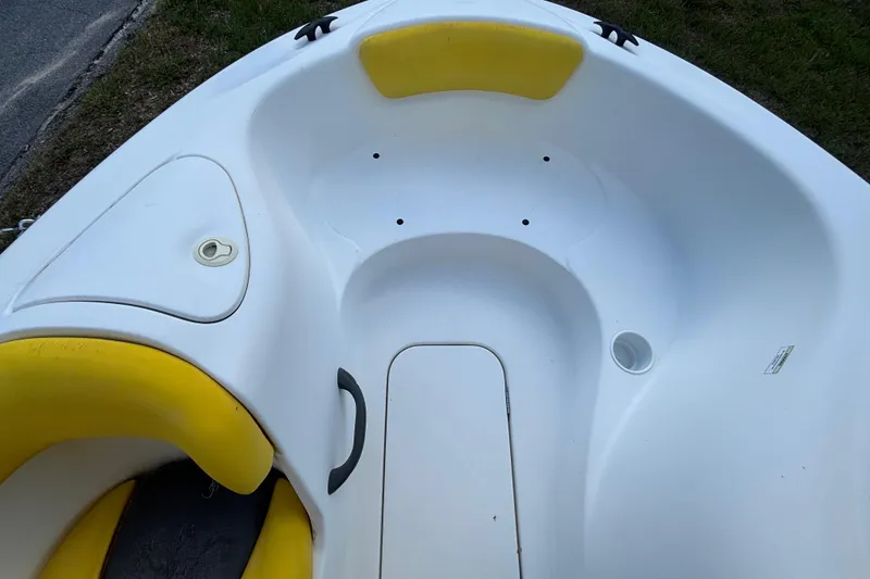 Slide: The Image of 2004 Sea-Doo Sportster LE DI boat interior with yellow accents and seating area. - 21