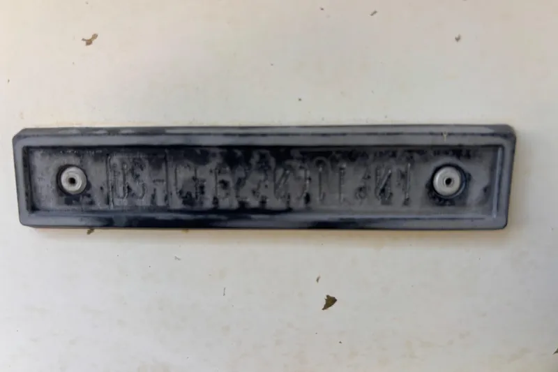 Slide: The Image of 2004 Sea-Doo Sportster LE DI boat identification plate, slightly worn and mounted on a surface. - 40