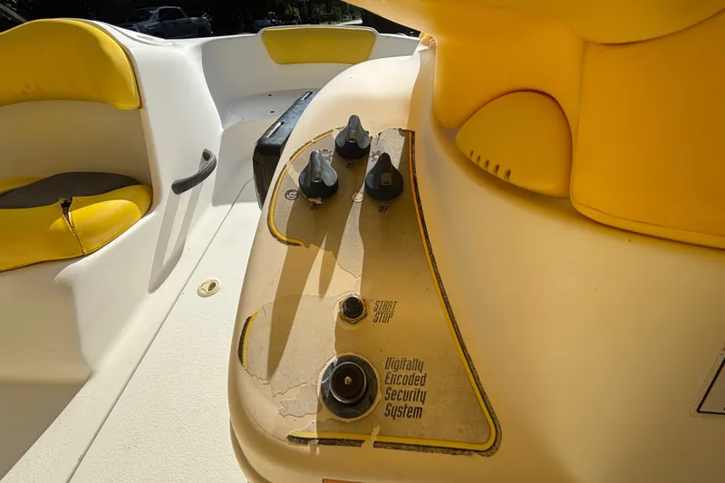 Slide: The Image of 2004 Sea-Doo Sportster LE DI boat interior with yellow seating and control panel. - 18