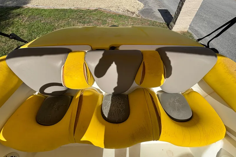 Slide: The Image of 2004 Sea-Doo Sportster LE DI boat seats, yellow and gray, showing wear and tear. - 30