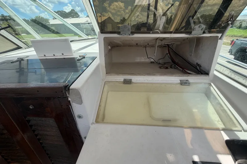 Slide: The Image of Open storage compartment on 1986 Grady-White Seafarer 226 boat, showing interior wiring. - 14
