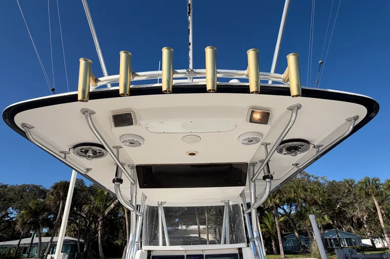 Slide: The Image of 2004 Venture 34 Cuddy boat, view of the overhead rod holders and canopy. - 18