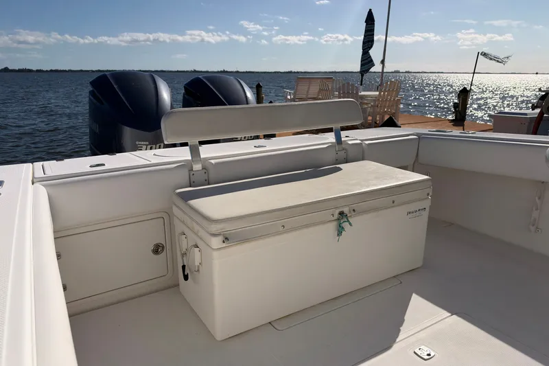 Slide: The Image of 2004 Venture 34 Cuddy boat interior with seating and twin Yamaha engines. - 68