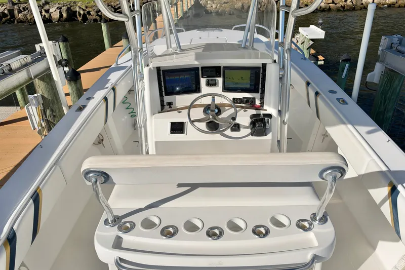 Slide: The Image of 2004 Venture 34 Cuddy boat cockpit with steering wheel and navigation screens. - 16