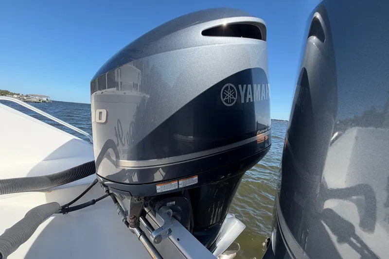 Slide: The Image of 2004 Venture 34 Cuddy with Yamaha outboard engines on open water. - 86