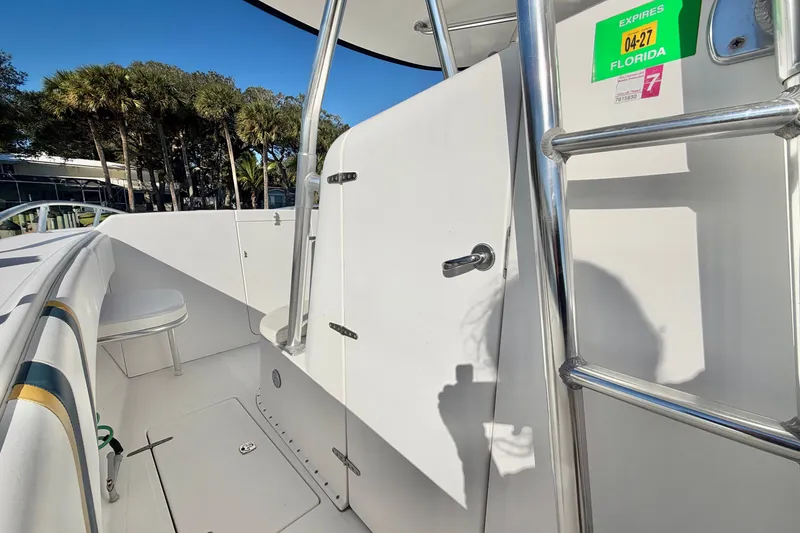 Slide: The Image of 2004 Venture 34 Cuddy boat interior with ladder and seating, Florida registration visible. - 38