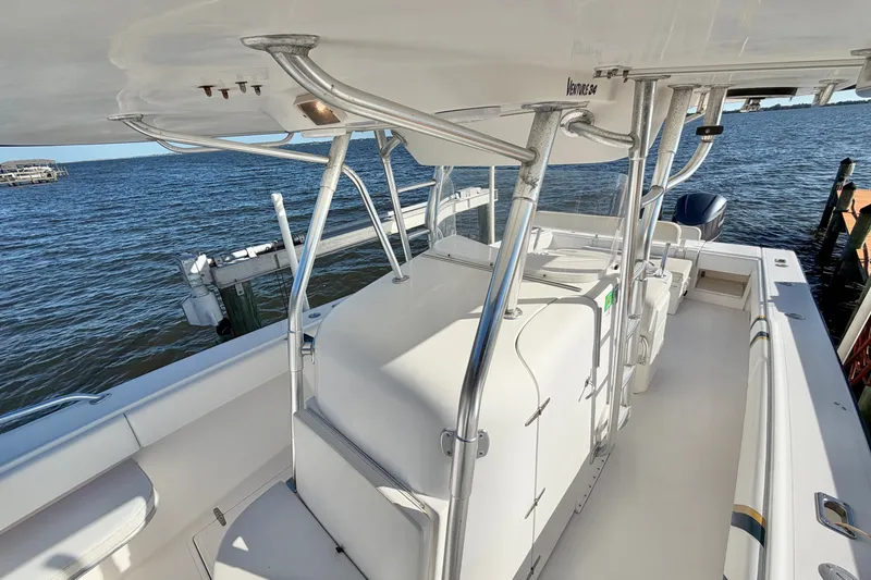Slide: The Image of 2004 Venture 34 Cuddy boat with sleek design, docked by the water. - 53