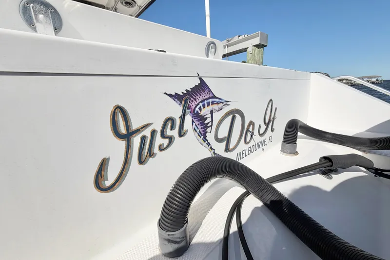 Slide: The Image of 2004 Venture 34 Cuddy boat with "Just Do It" logo, Melbourne, FL. - 90