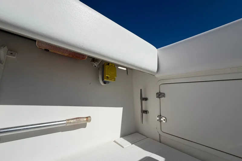 Slide: The Image of 2004 Venture 34 Cuddy boat interior detail with storage compartment and railing. - 98