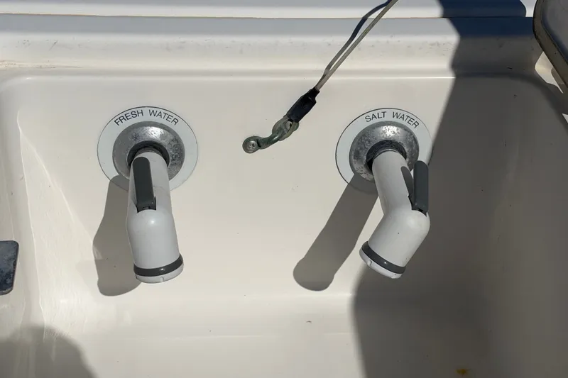 Slide: The Image of Fresh and salt water taps on a 2004 Venture 34 Cuddy boat. - 78