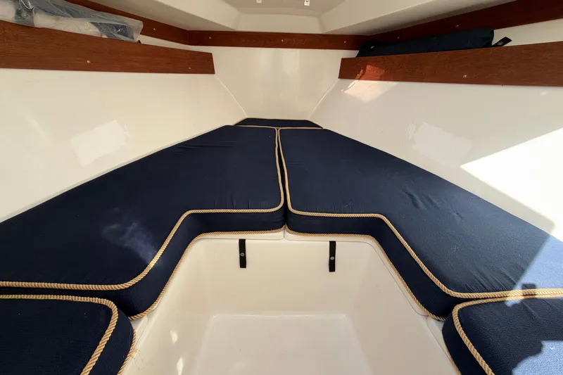 Slide: The Image of 2004 Venture 34 Cuddy cabin interior with navy cushions and wooden accents. - 71