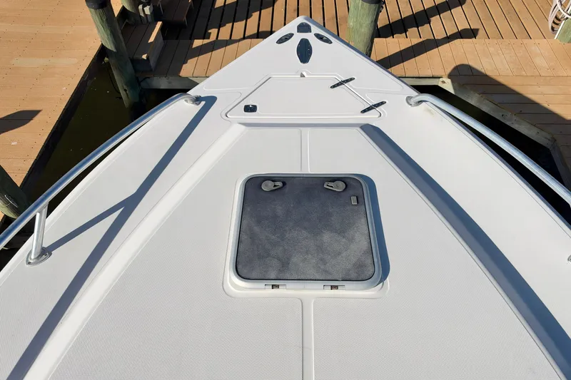 Slide: The Image of Bow view of a 2004 Venture 34 Cuddy boat docked at a marina. - 32