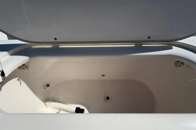 Slide: The Image of Open storage compartment on 2004 Venture 34 Cuddy boat, showing interior details. - 81