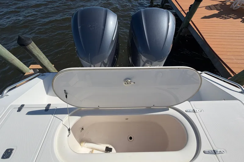 Slide: The Image of Open storage compartment on 2004 Venture 34 Cuddy boat with dual outboard motors. - 80