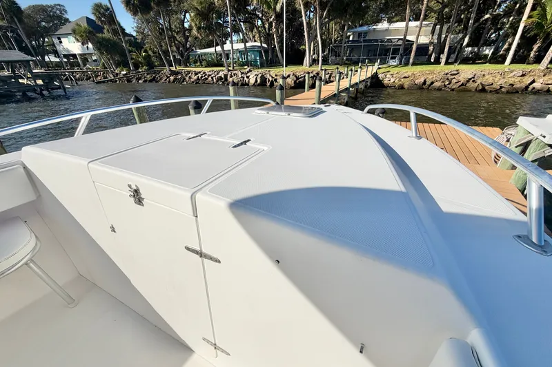 Slide: The Image of 2004 Venture 34 Cuddy boat deck with railing, dockside view. - 31