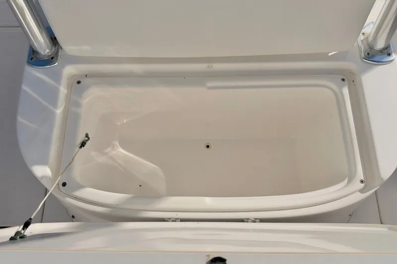 Slide: The Image of Open storage compartment on a 2004 Venture 34 Cuddy boat. - 56