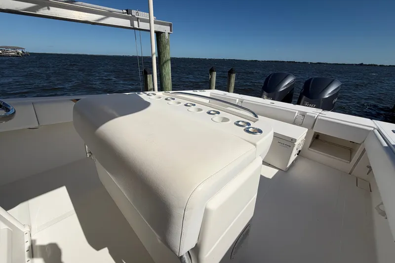 Slide: The Image of 2004 Venture 34 Cuddy boat interior with dual engines, docked by the water. - 104