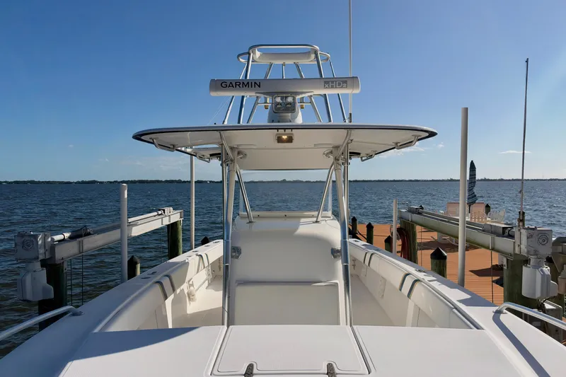 Slide: The Image of 2004 Venture 34 Cuddy boat docked by the water on a sunny day. - 36