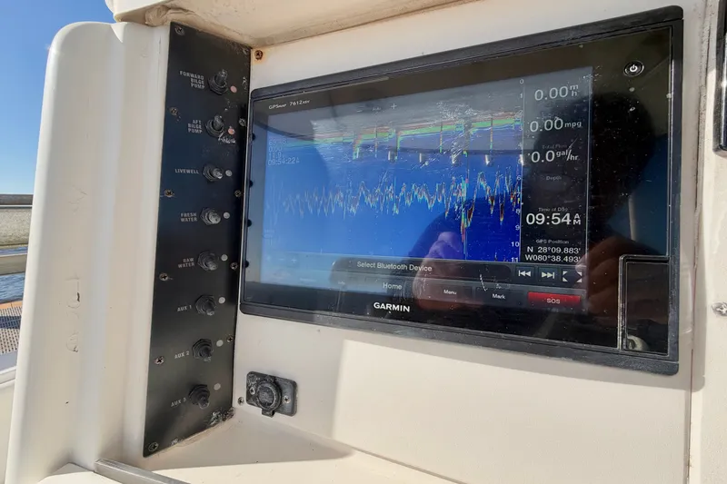 Slide: The Image of Garmin GPS display on 2004 Venture 34 Cuddy boat dashboard with control panel. - 21