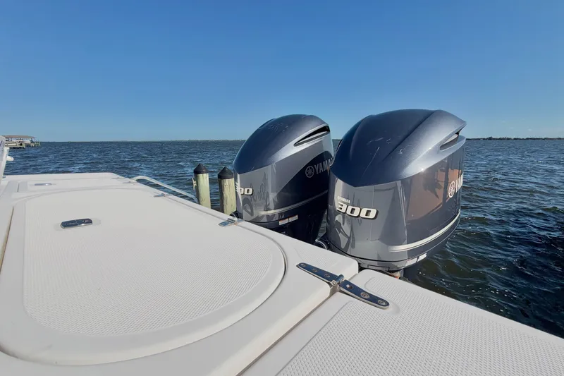 Slide: The Image of 2004 Venture 34 Cuddy boat with twin Yamaha 300 engines on open water. - 83