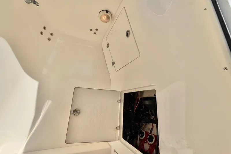 Slide: The Image of Interior view of a 2004 Venture 34 Cuddy boat with open storage compartments. - 41