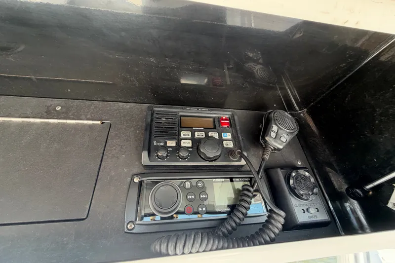 Slide: The Image of Control panel of a 2004 Venture 34 Cuddy boat with communication equipment. - 109