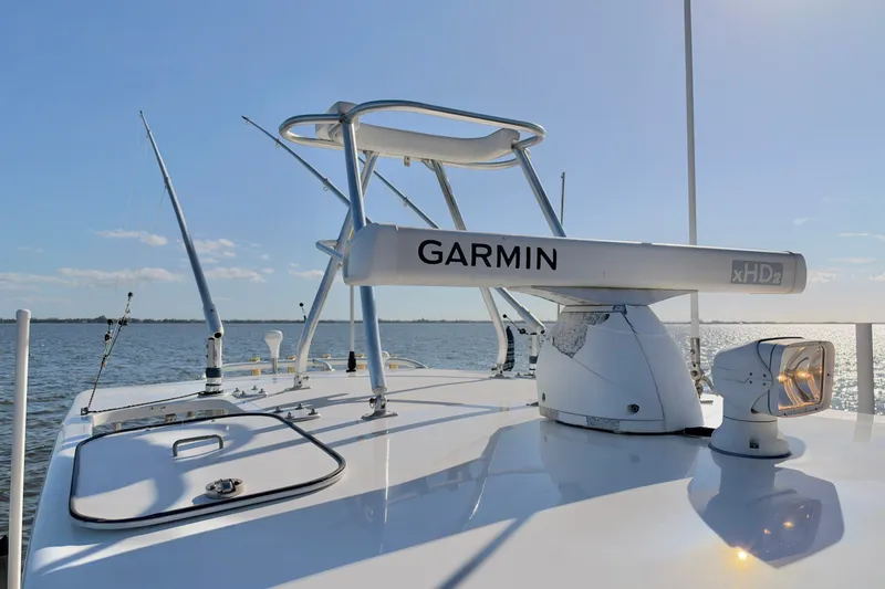 Slide: The Image of 2004 Venture 34 Cuddy boat with Garmin radar on calm water. - 51