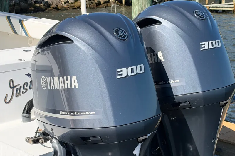 Slide: The Image of Twin Yamaha 300 four-stroke engines on a 2004 Venture 34 Cuddy boat. - 7