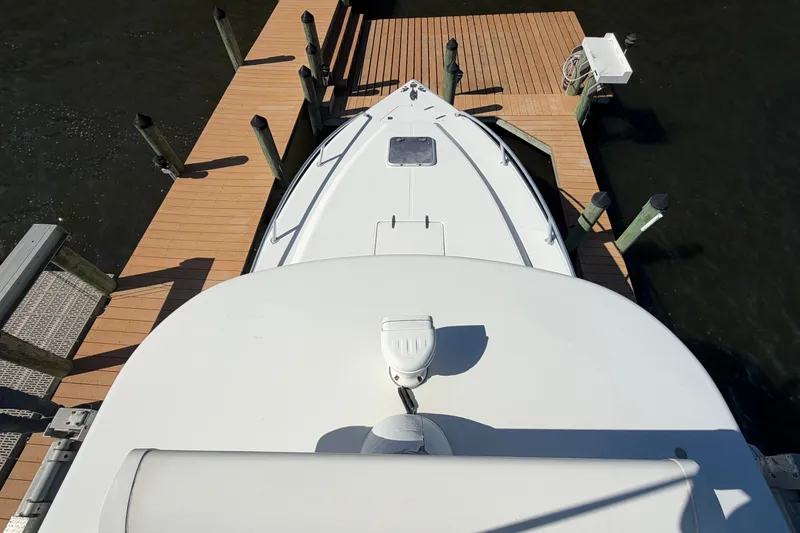 Slide: The Image of Overhead view of a 2004 Venture 34 Cuddy boat docked at a wooden pier. - 95