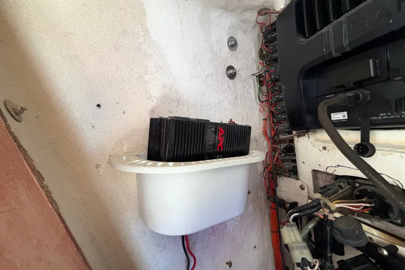 Slide: The Image of Electrical components and wiring inside a 2004 Venture 34 Cuddy boat. - 102