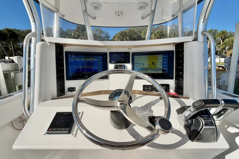 Slide: The Image of Helm of 2004 Venture 34 Cuddy boat with navigation screens and steering wheel. - 19