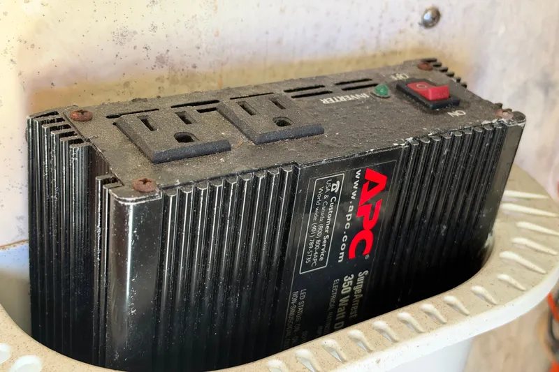 Slide: The Image of APC power inverter in a 2004 Venture 34 Cuddy boat, showing outlets and power switch. - 101