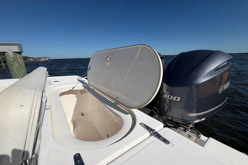 Slide: The Image of 2004 Venture 34 Cuddy boat with open hatch and Yamaha 300 engine on water. - 82