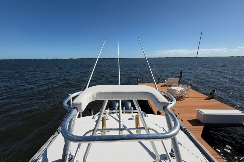 Slide: The Image of 2004 Venture 34 Cuddy boat docked by a wooden pier on a sunny day. - 93