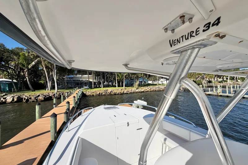 Slide: The Image of 2004 Venture 34 Cuddy boat docked by a scenic waterfront. - 45