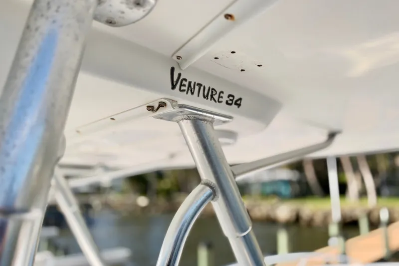 Slide: The Image of Close-up of 2004 Venture 34 Cuddy boat structure with logo visible. - 29