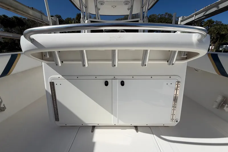 Slide: The Image of 2004 Venture 34 Cuddy boat interior with rod holders and storage compartments. - 106