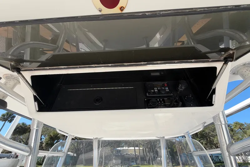 Slide: The Image of 2004 Venture 34 Cuddy boat electronics compartment with radio and controls. - 108