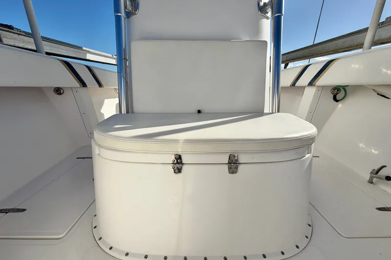 Slide: The Image of 2004 Venture 34 Cuddy boat seating area with white cushioned bench. - 55