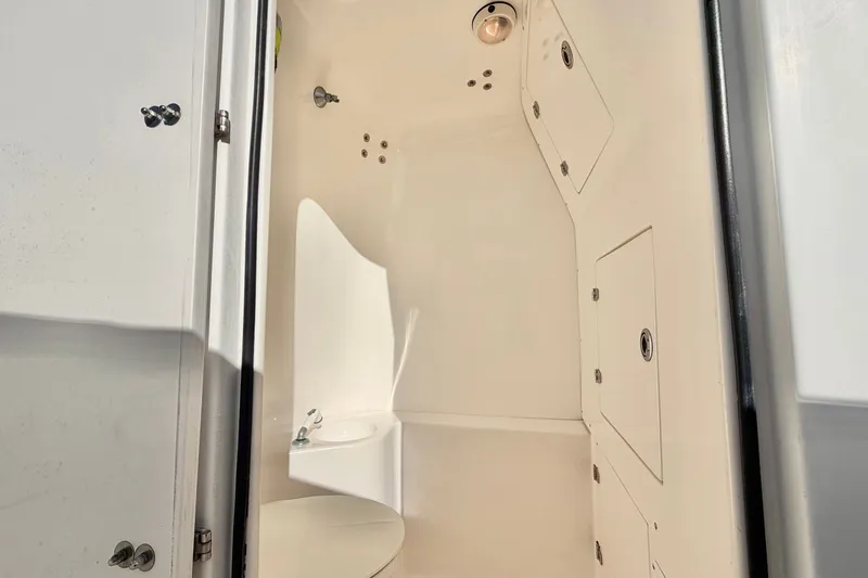 Slide: The Image of 2004 Venture 34 Cuddy boat interior with storage compartments and sink. - 40