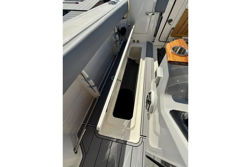 Slide: The Image of 2024 Boston Whaler 360 Outrage boat interior storage compartment with sleek design. - 37