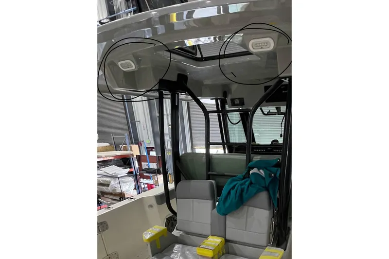 Slide: The Image of 2024 Boston Whaler 360 Outrage interior with seating and overhead lighting. - 68