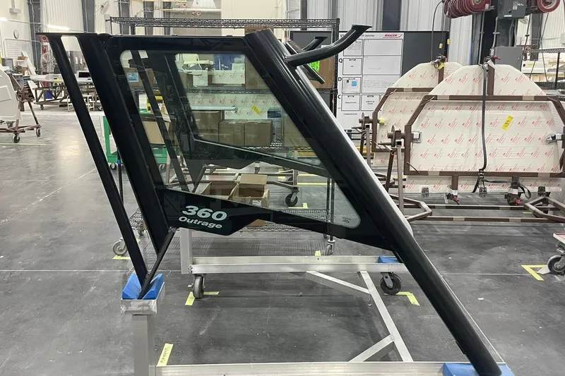 Slide: The Image of 2024 Boston Whaler 360 Outrage windshield in a manufacturing facility. - 53