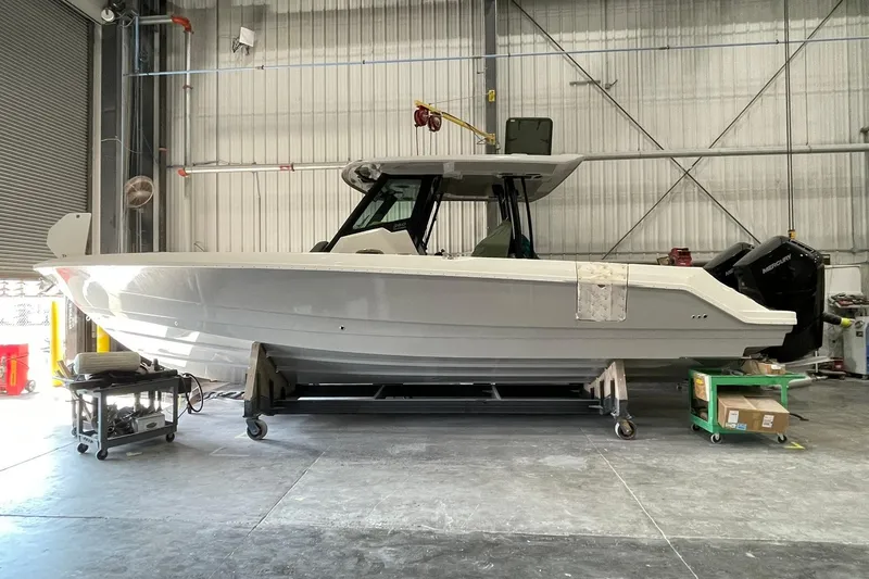Slide: The Image of 2024 Boston Whaler 360 Outrage boat in a warehouse setting. - 71