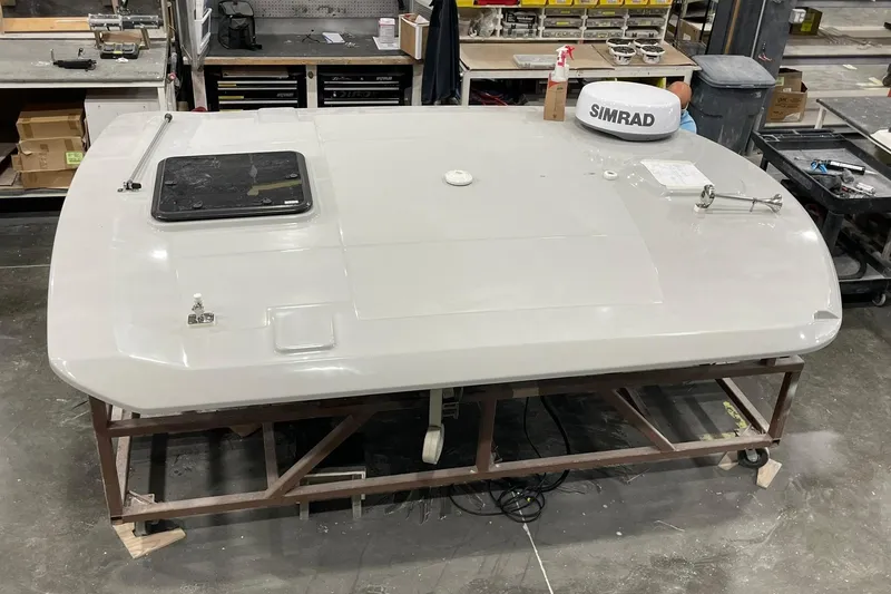 Slide: The Image of 2024 Boston Whaler 360 Outrage boat component in workshop setting. - 62