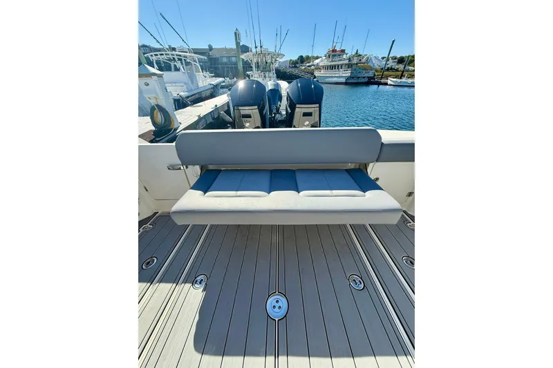 Slide: The Image of 2024 Boston Whaler 360 Outrage boat with cushioned seating and twin engines at the dock. - 35